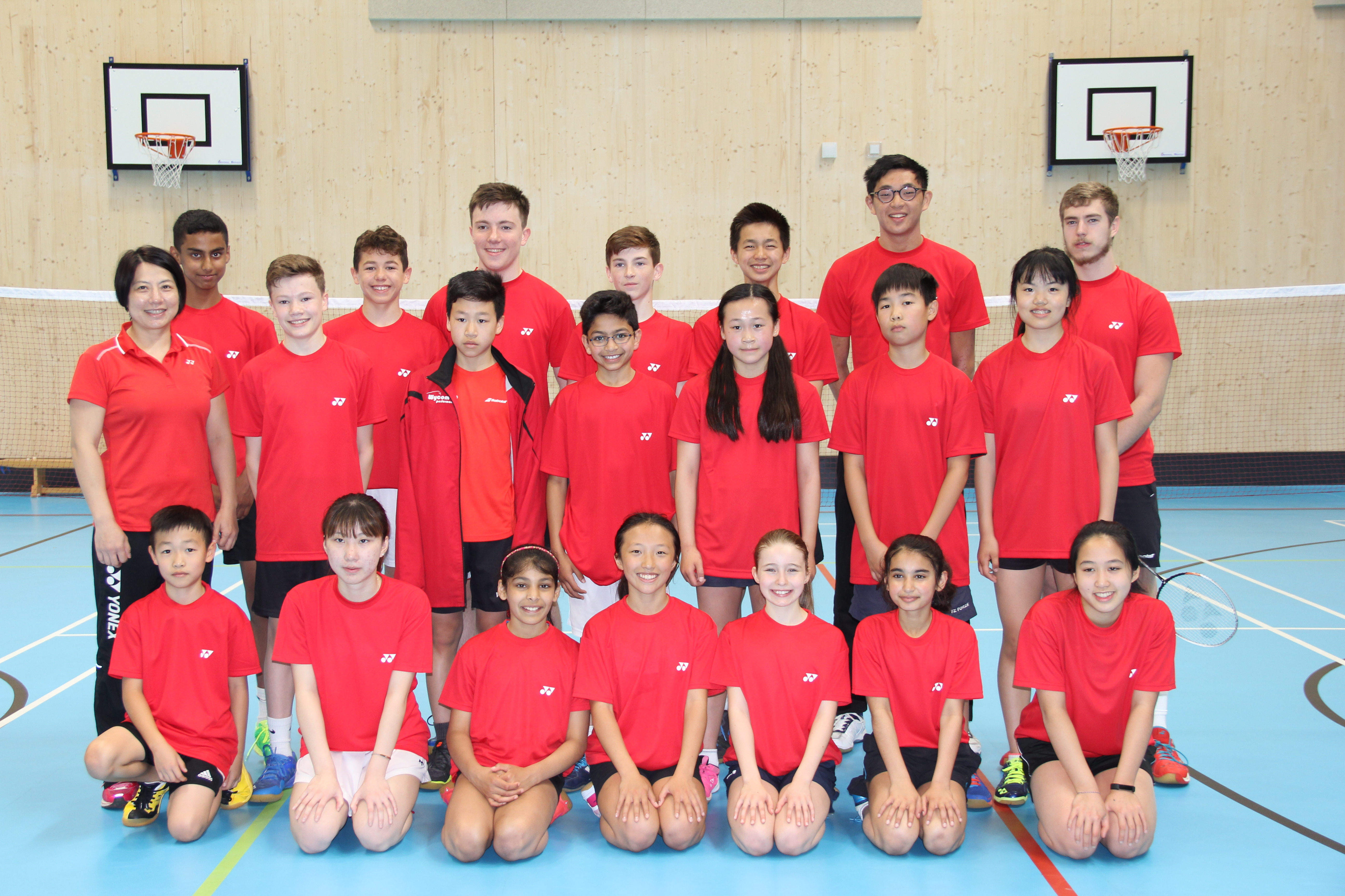 Junior badminton camp group with coaches